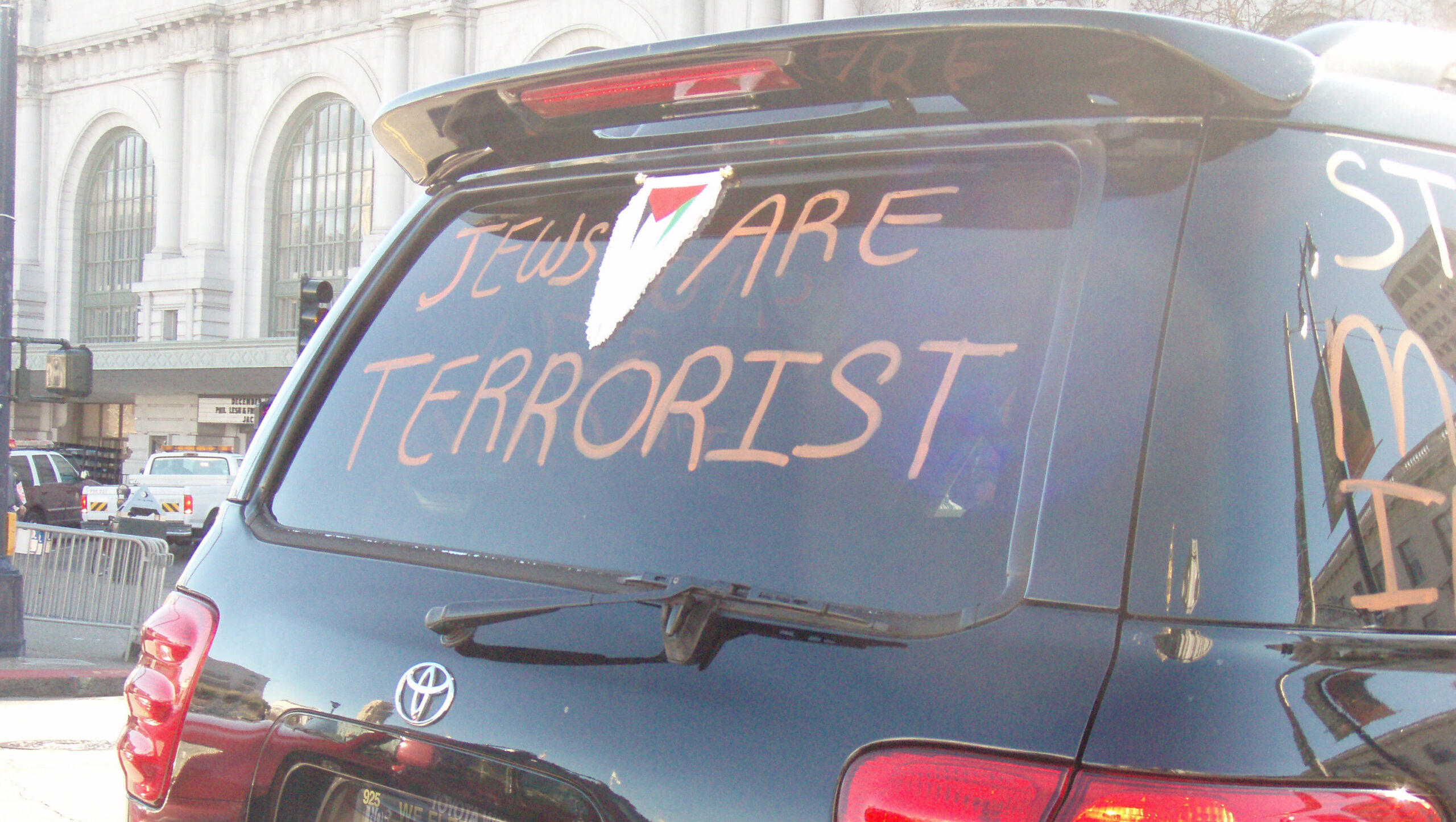 The back of an SUV with "Jews are terrorist" written on it