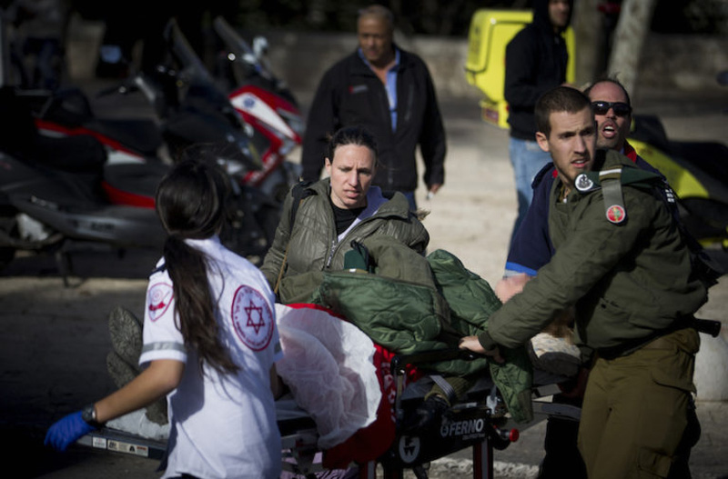 Medics attend to the injured at the scene where a truck rammed a group of soldiers in eastern Jerusalem, Jan. 8, 2017. (Photo-JTA-Flash90-Yonatan Sindel)