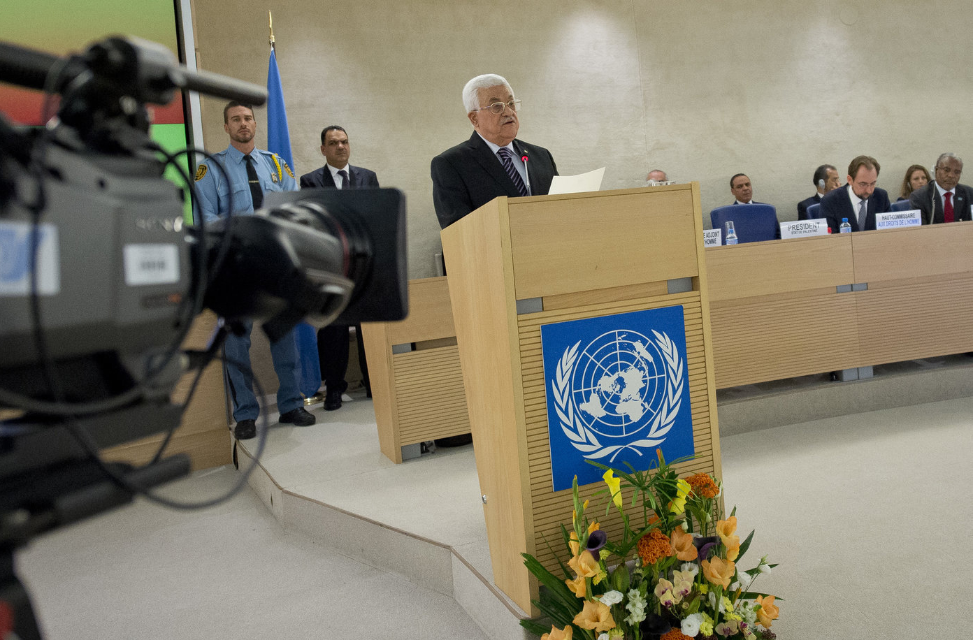 Abbas stands at a podium with the UN seal on it