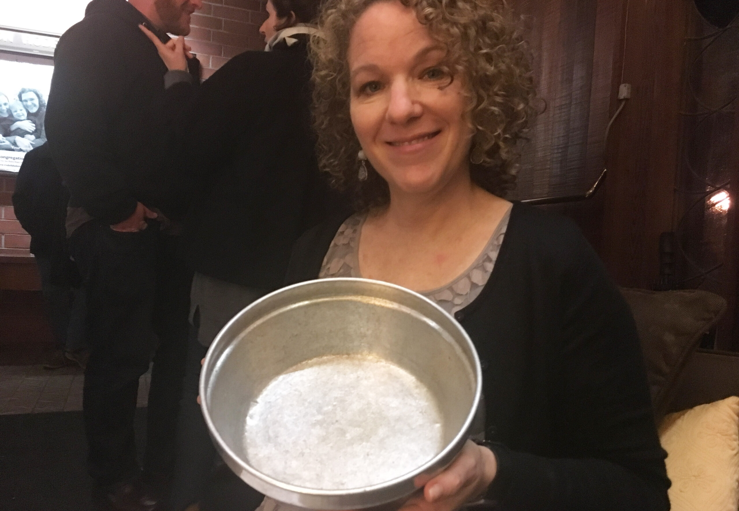 Friedman holding up a well-worn metal bowl