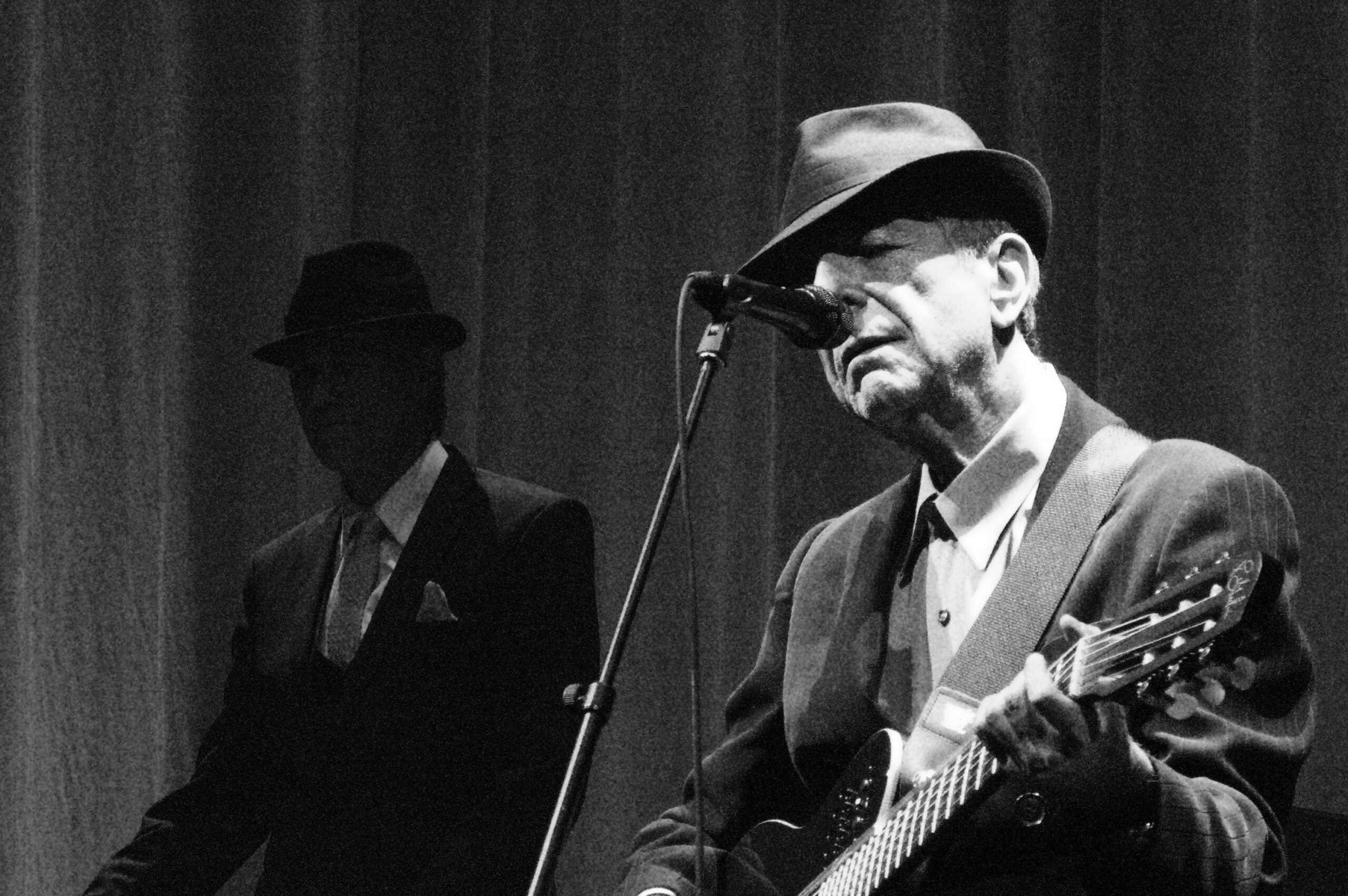 leonard cohen in a fedora on stage