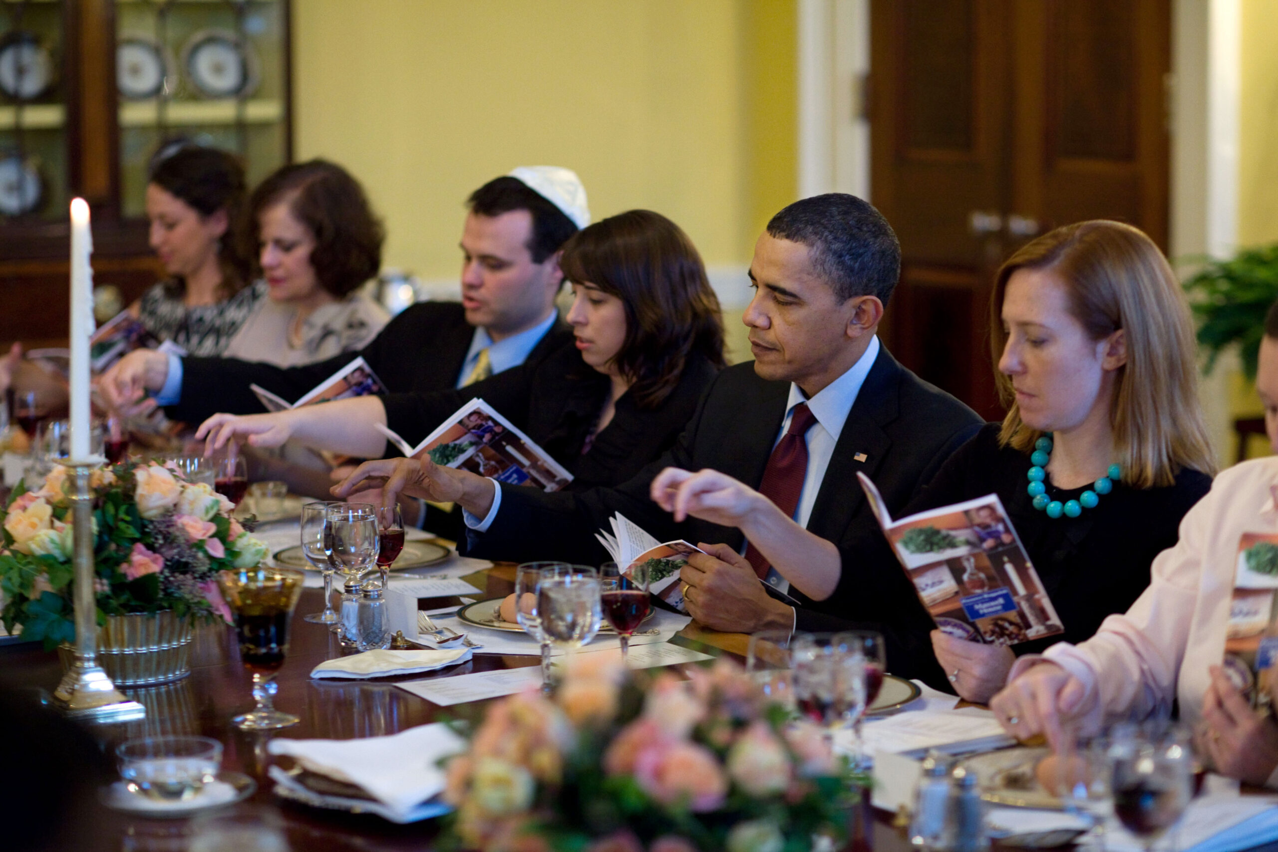 Obama and guests dip their fingers in wine to recite the ten plagues