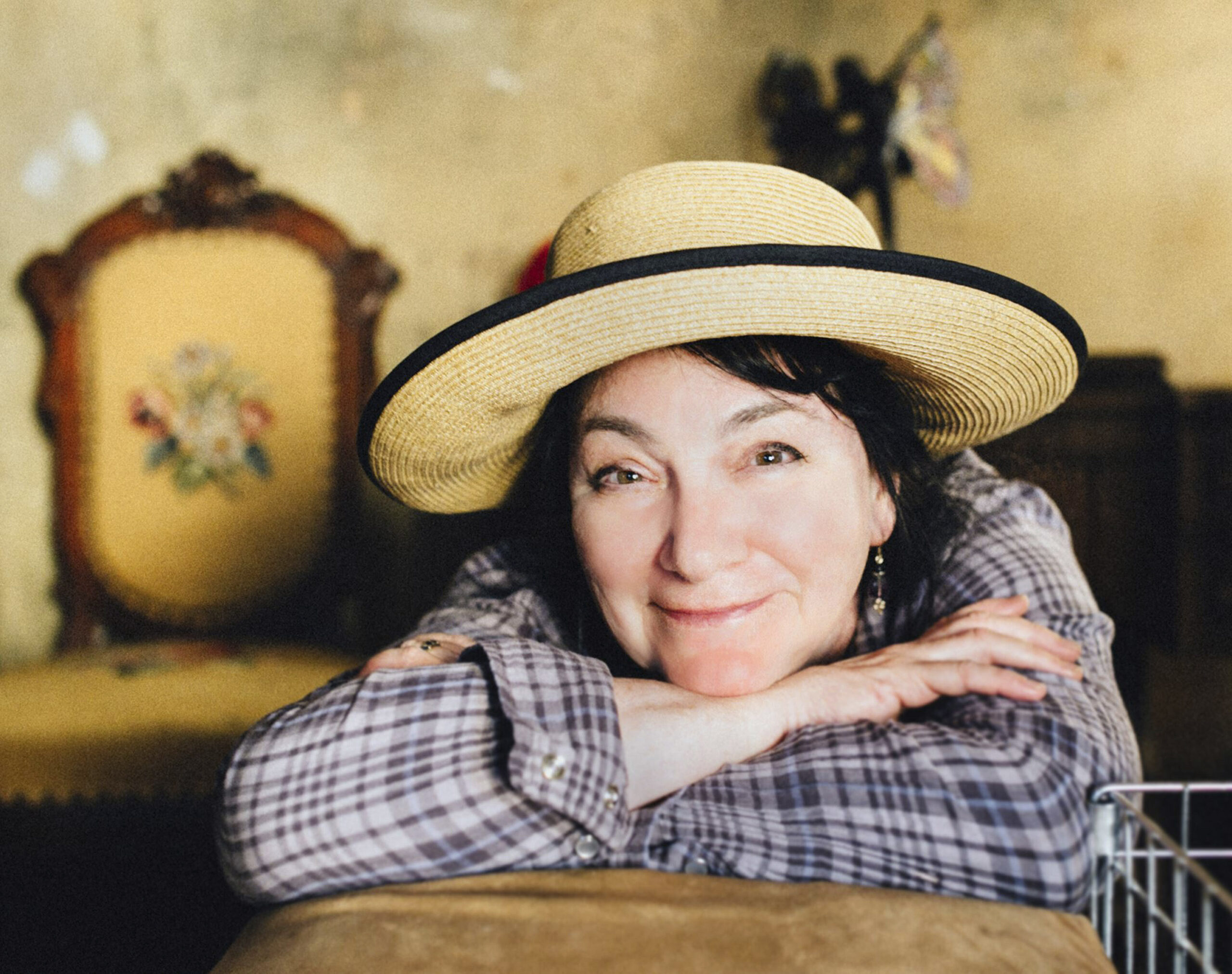 photo of weisman smiling and wearing a straw hat