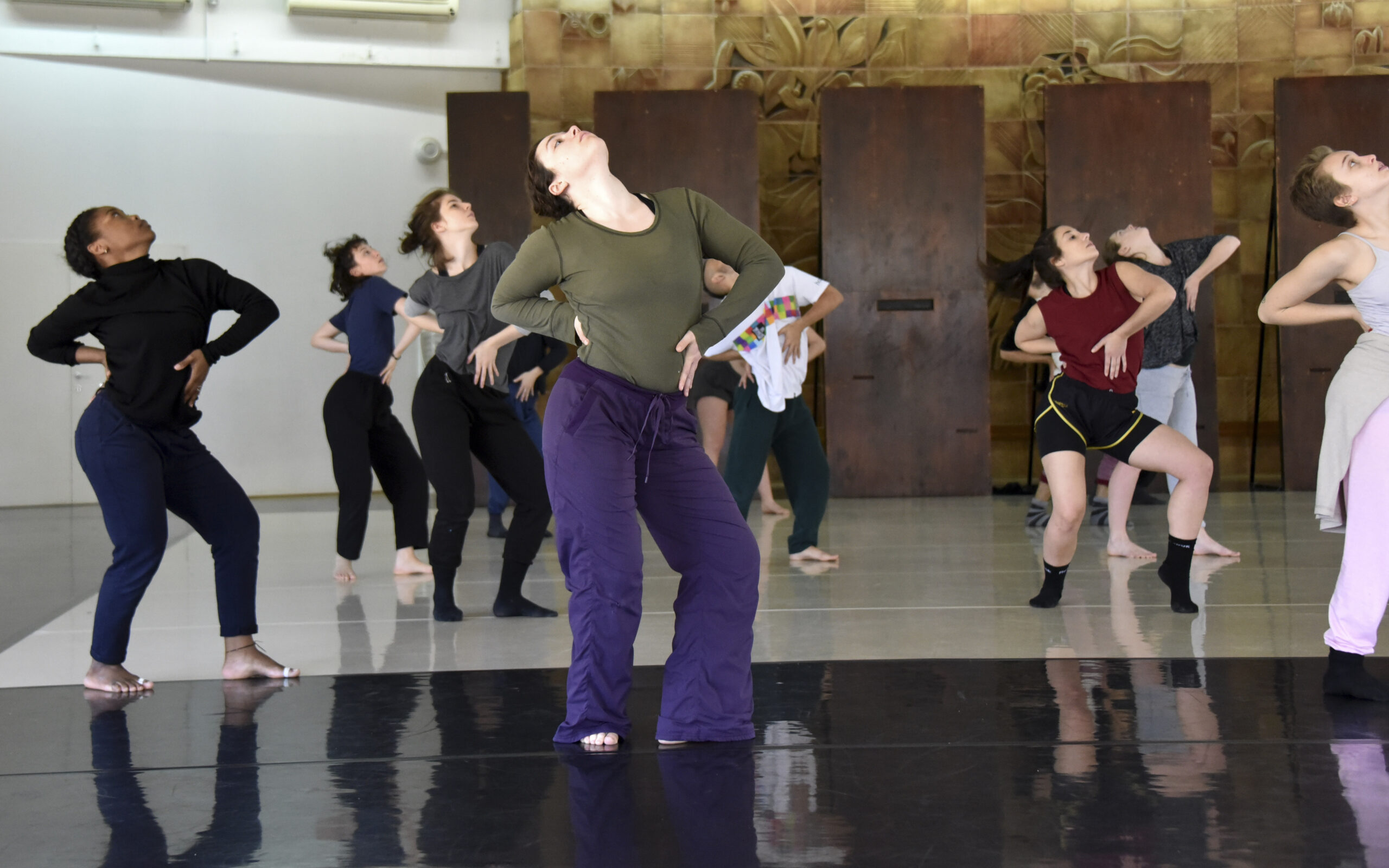 charlson and a room of other dancers strike the same defiant pose