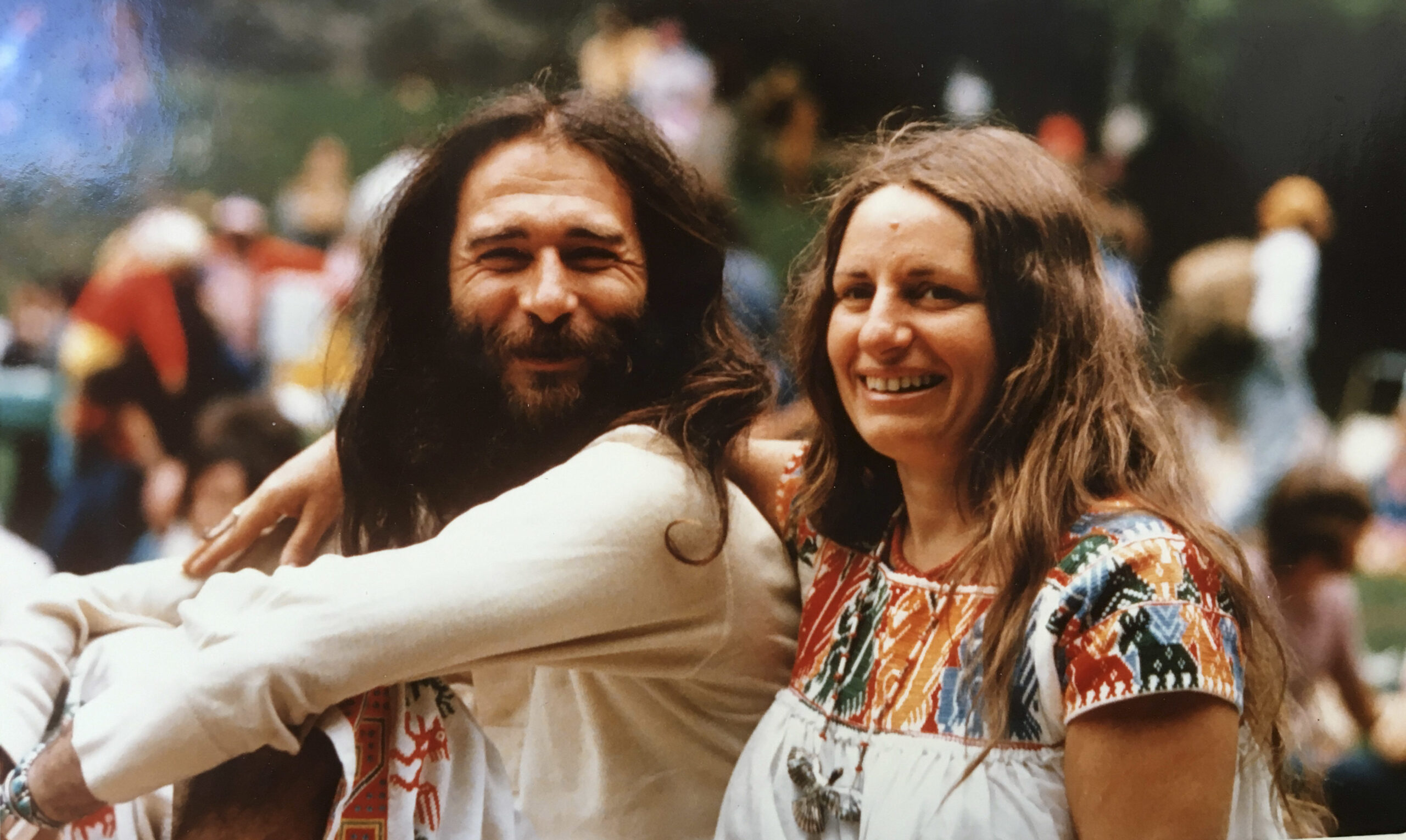 long hair, pot smoke wafts through the air; they sit on the grass smiling