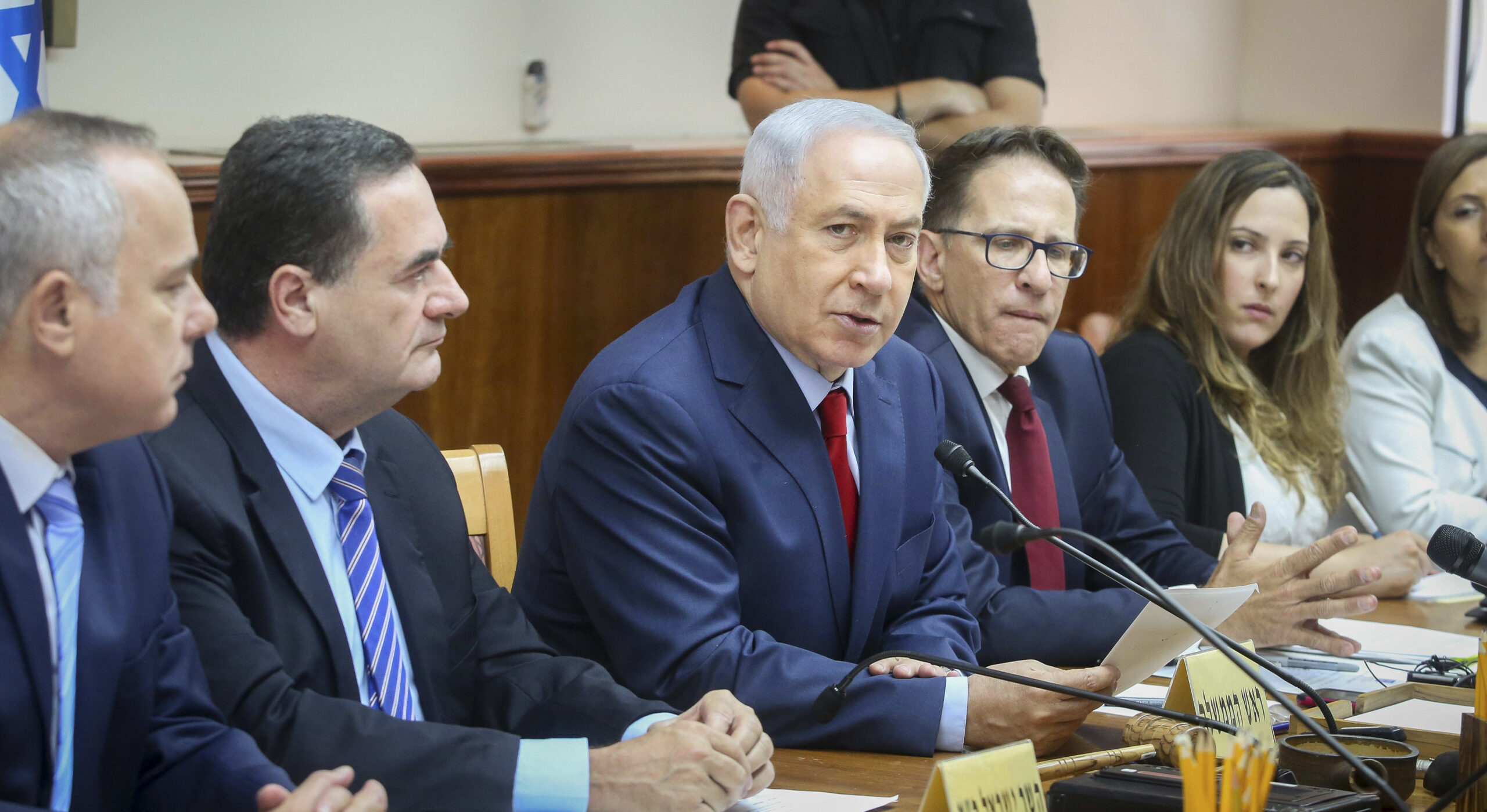 netanyahu sits at a table with other men