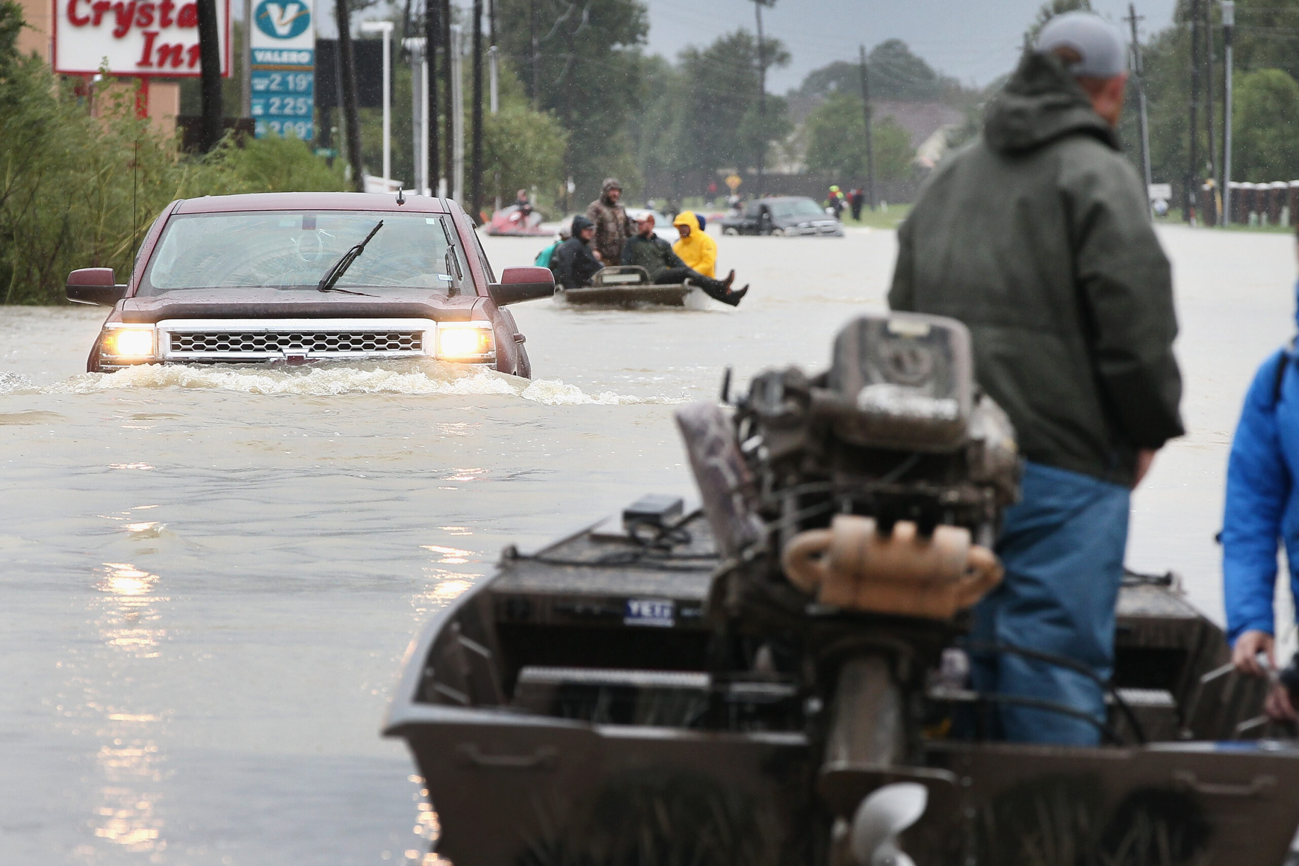 Rescue workers and volunteers helping residents make their way out of a flooded neighborhood after it was inundated with rain following Hurricane Harvey in Houston, Aug. 29, 2017. (Photo/JTA-Scott Olson-Getty Images)