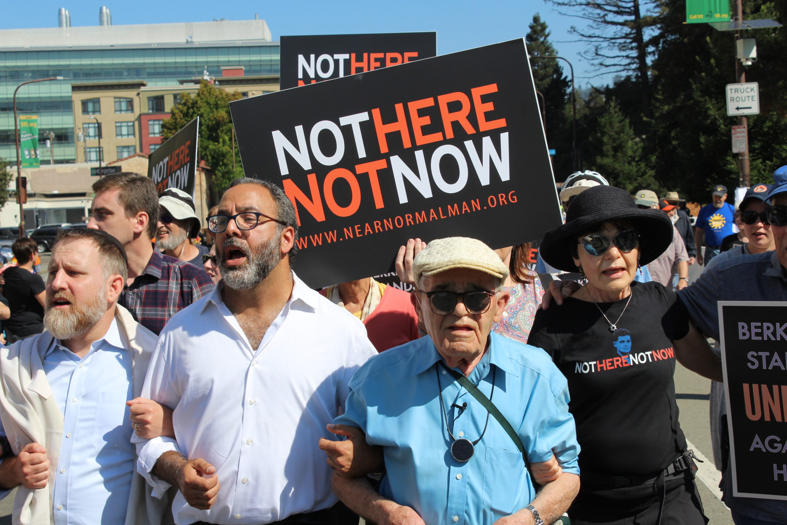 Holocaust survivor Ben Stern (center, wearing blue shirt) leads about 200 marchers to the "Bay Area Rally Against Hate" in Berkeley, accompanied by his daughter, Charlene Stern (on right), and Rabbis Menachem Creditor of Congregation Netivot Shalom (holding Ben's arm) and Yonatan Cohen of Congregation Beth Israel (far left), Aug. 27, 2017. (Photo/Rob Gloster)