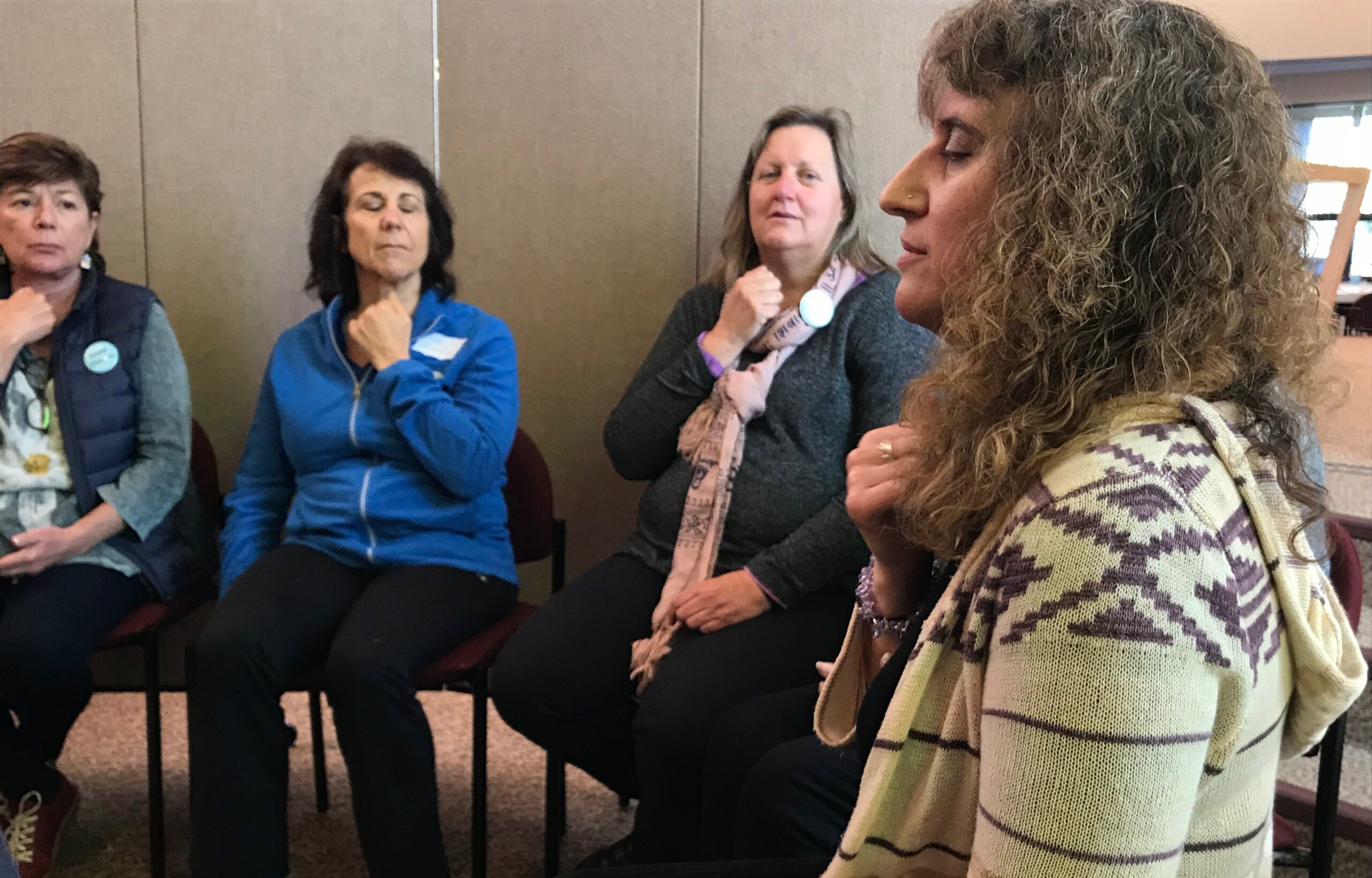 Santa Rosa psychotherapist Alissa Hirschfeld-Flores (right) leads a group in Emotional Freedom Technique tapping, which uses acupressure points to relieve stress and induce calming. (Photo/Shoshana Hebshi)