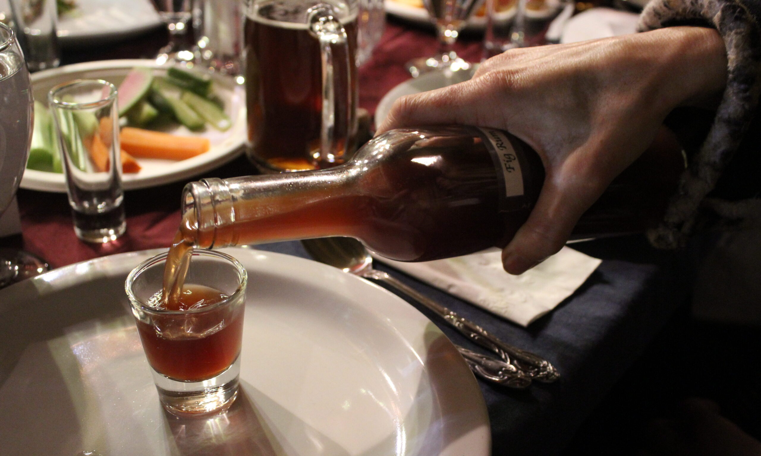 Homemade Fig Rum, among a number of other booze forms, flowed freely at Urban Adamah's 2018 Tu B'Shevat seder. (Photo/David A.M. Wilensky)