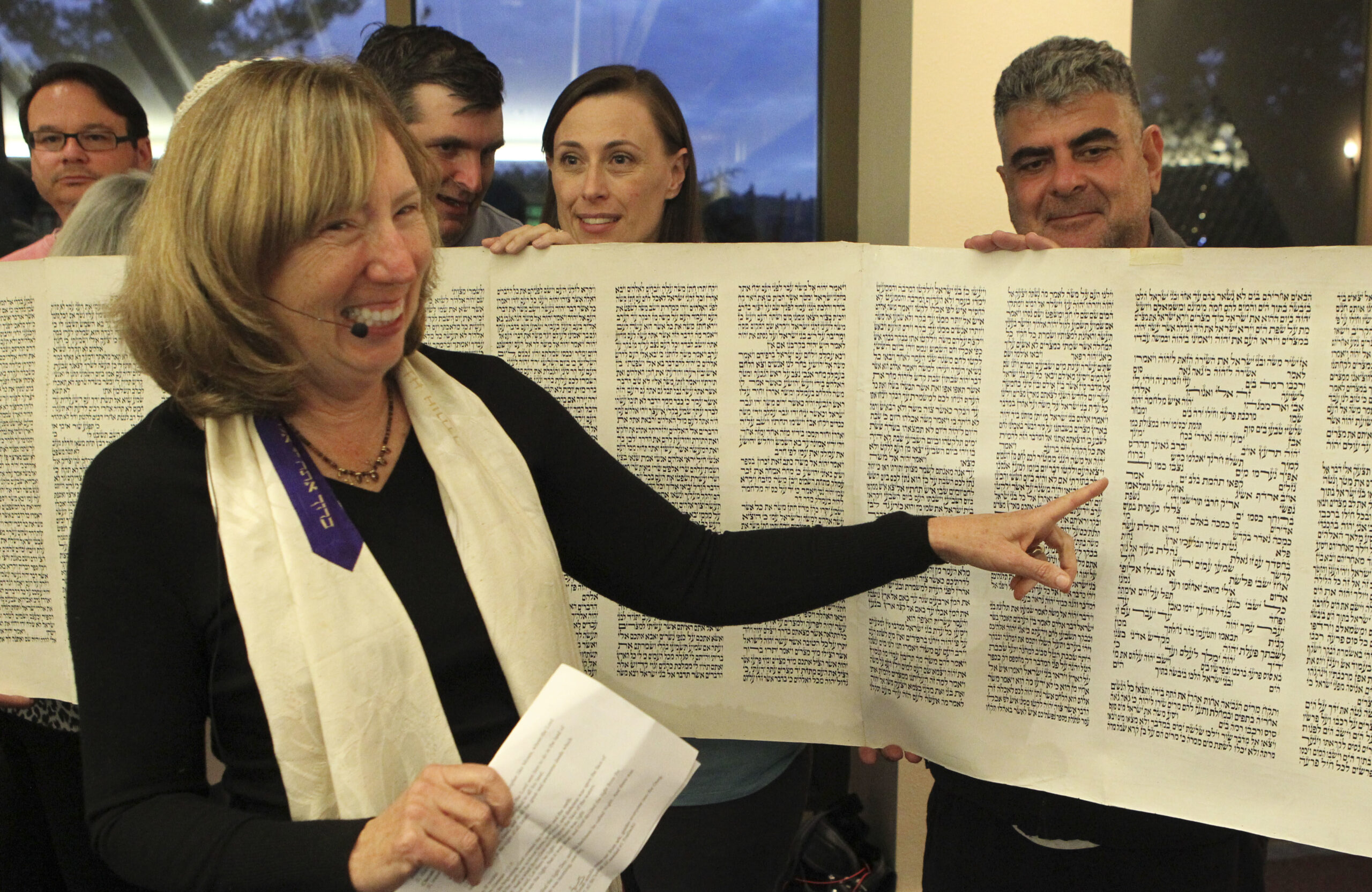 Rabbi Judy Shanks stands in the center of an unrolled Torah scroll on Simchat Torah at Temple Isaiah of Lafayette,
 (Photo/Courtesy Jen Boxerman)