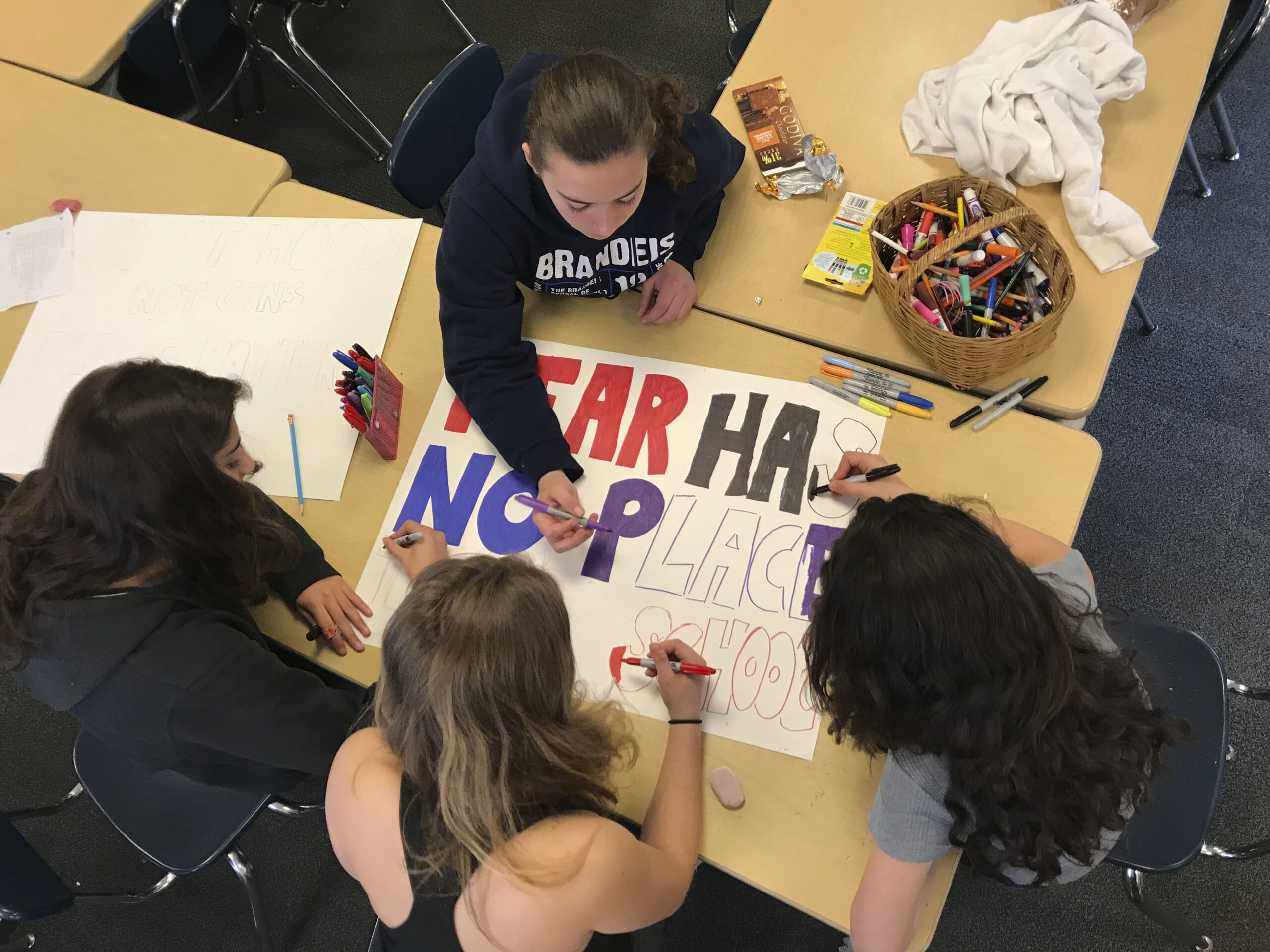 Student at Brandeis School of San Francisco making posters for the March 14 school walkout. (Photo/Courtesy Brandeis SF)
