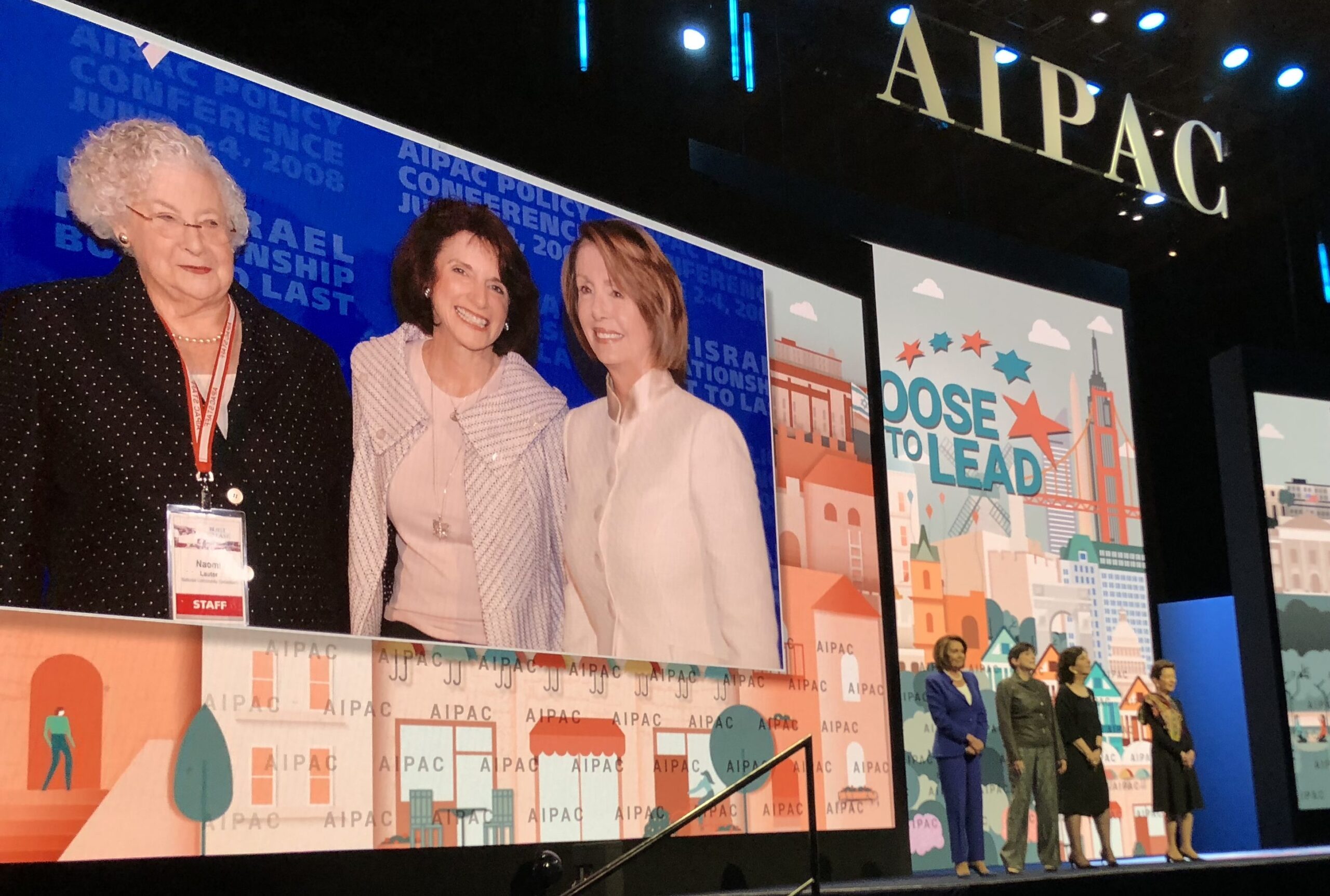 Rep. Nancy Pelosi, Amy Friedkin, Anita Friedman and Roselyne Swig remembering the late Naomi Lauter (on screen, left) at the AIPAC conference March 5 in Washington, D.C. (Photo/Jonathan Wornick)