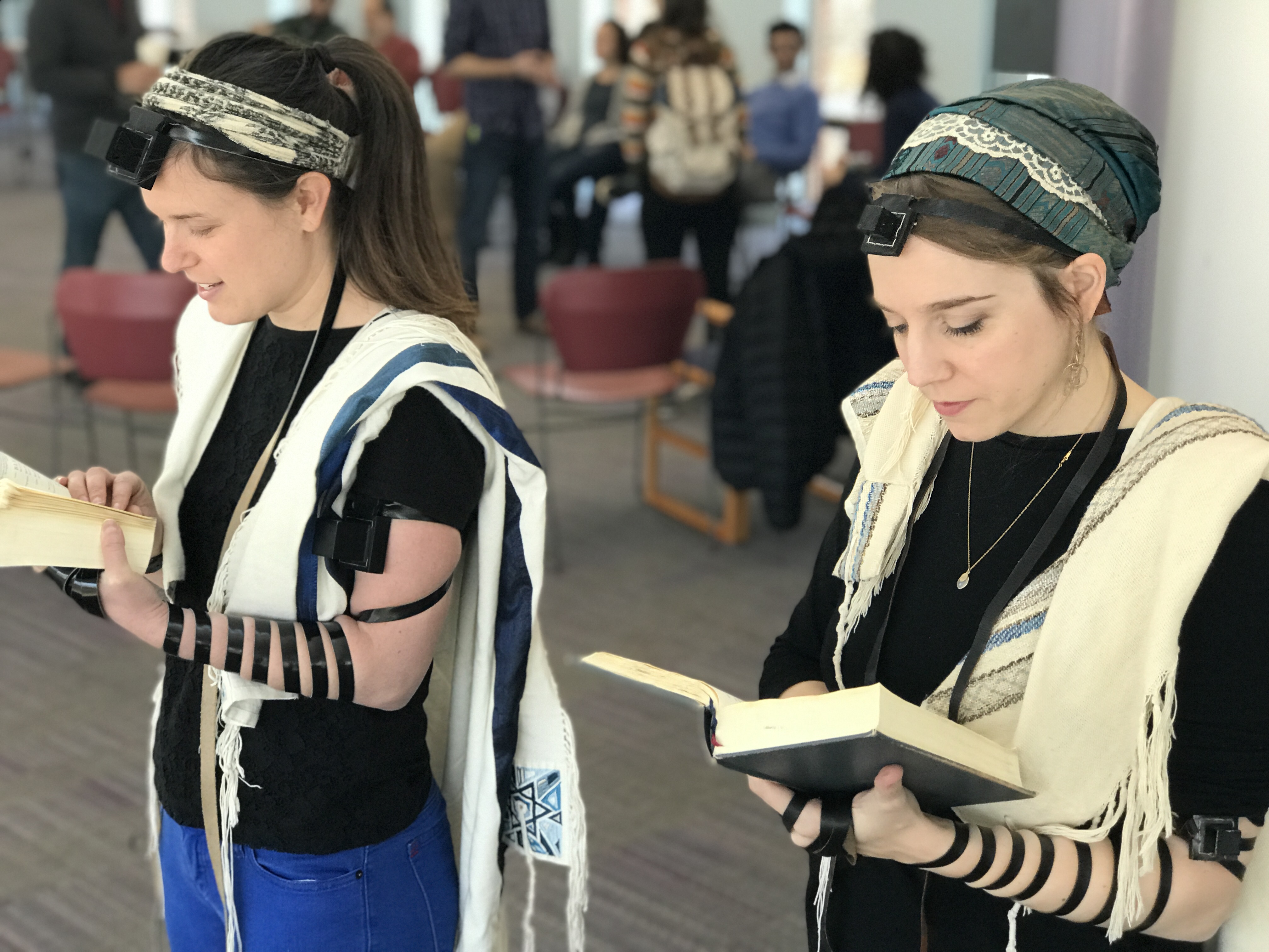 Rabbinical students at Hebrew College near Boston, including Gita Karasov, left, are creating a video that shows women, transgender and non-binary Jews demonstrating how to wear tefillin. (Photo/JTA-Dena Trugman)