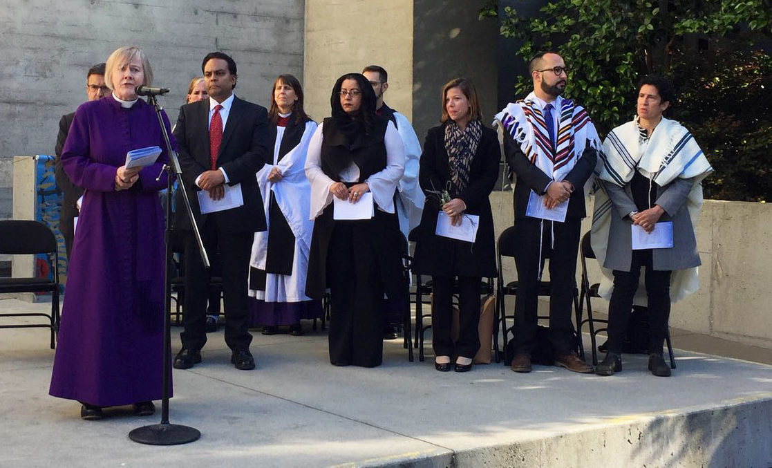 Rev. Dr. Ellen Clark-King speaking at an interfaith vigil for immigrant children at Grace Cathedral in San Francisco, June 21. Far right: Abby Porth of Jewish Community Relations Council with Rabbis Jason Rodich and Sydney Mintz of Congregation Emanu-El (Photo/SFJCRC-Twitter)