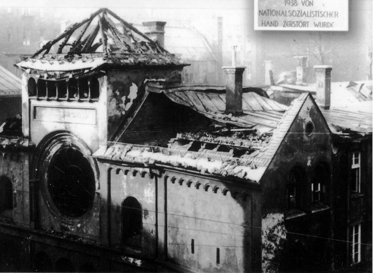 a ruined synagogue, roof caved in and windows smashed, seen from above