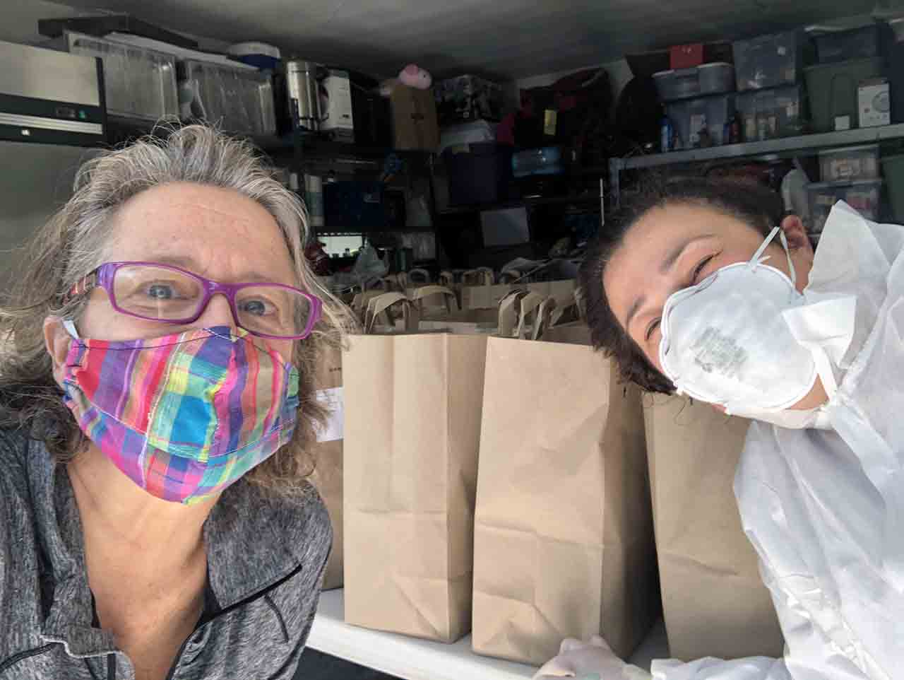 Kathryn Winogura of Jewish Family & Community Services East Bay and Michaela Schiffer of Julia’s Kosher Kitchen ready meals for delivery. (Photo/Courtesy JFCS East Bay)