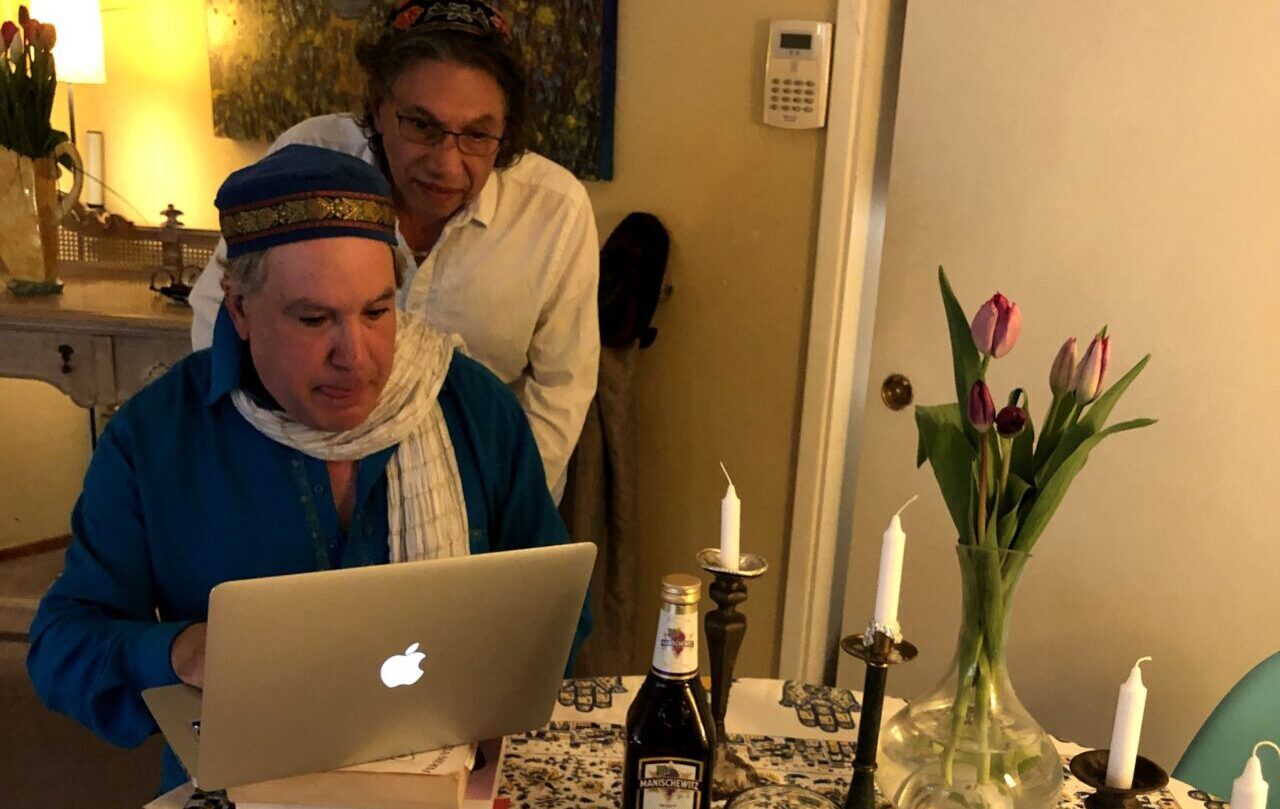 Bruce Bierman (seated) with husband Gilberto Melendez prepares to lead a virtual dance (Photo/Vaschelle André)
