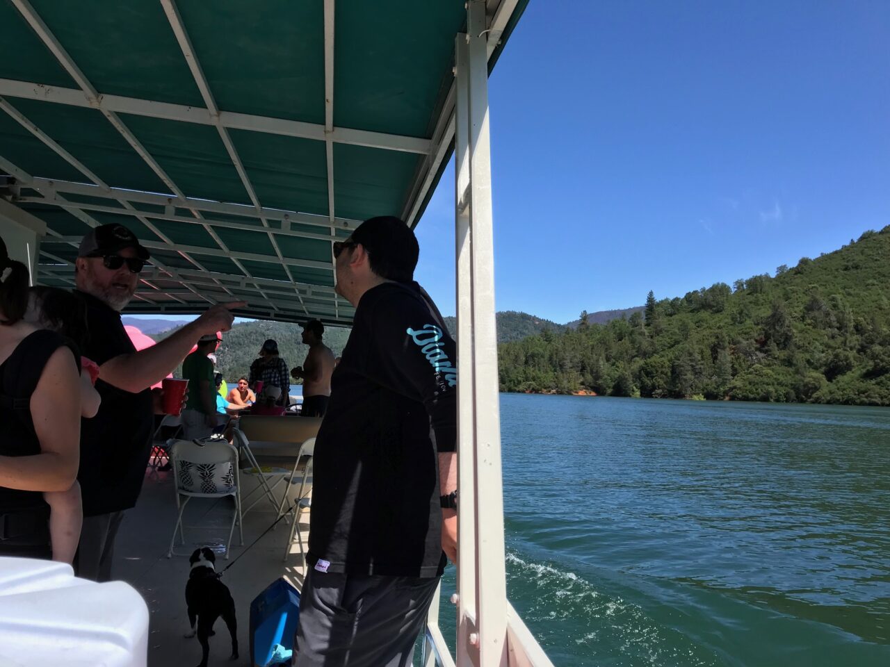 Two men speak on a boat