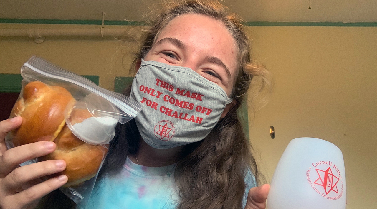 Cornell University student Aliza Saunders shows off the supplies she got from Cornell Hillel to celebrate Shabbat on her own. (Photo/Courtesy Cornell Hillel)