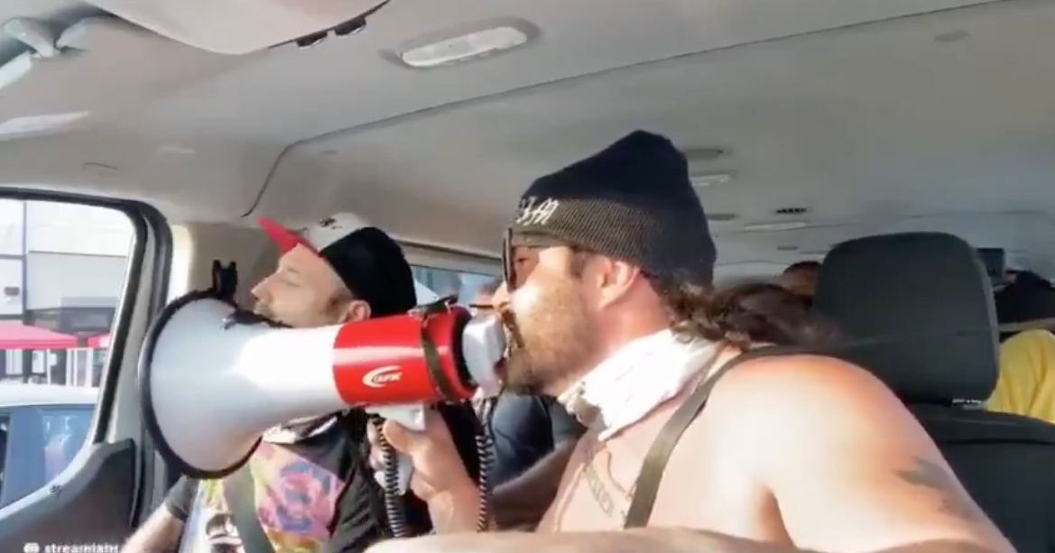 Screenshot of a video posted Aug. 23 on Goyim TV of Jon Minadeo shouting at people on the street in Los Angeles through a megaphone.