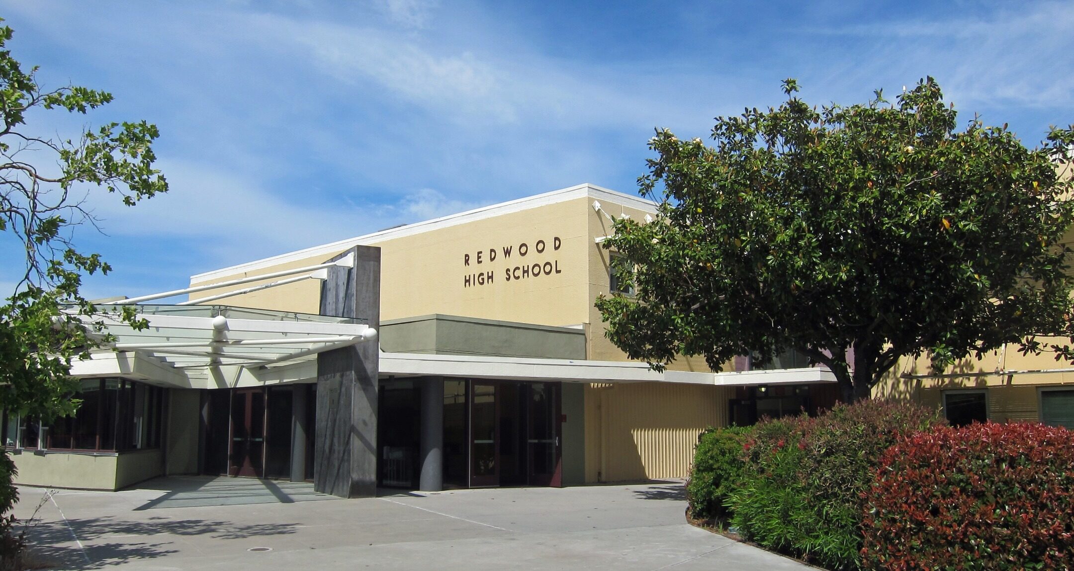 the main entrance to a yellow public school building