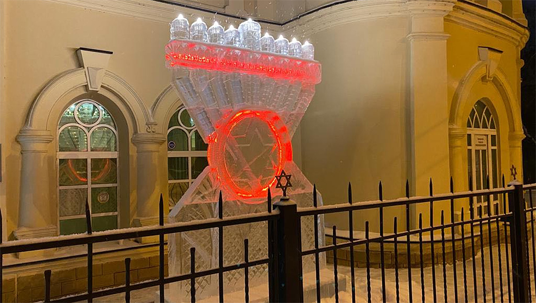 Snow falls on a Hanukkah Menorah made of ice in Tomsk, Russia, Dec. 8, 2020. (Photo/JTA-Levy Kaminetsky)