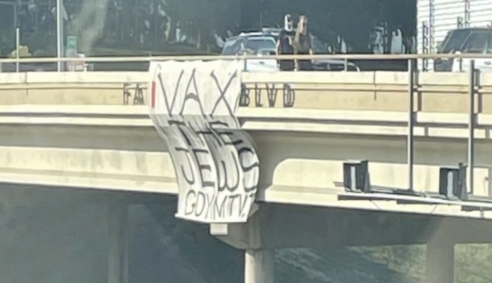 Goyim Defense League members hang an antisemitic banner from an overpass in Austin, Texas, Oct. 24, 2021. (Screenshot/CBS Austin)