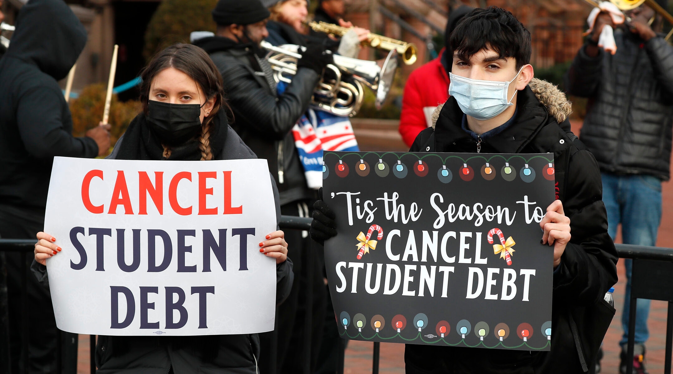 Activists hold signs calling on President Joe Biden to cancel student debt and not resume student loan payments outside the White House, Dec. 15, 2021. (Photo/JTA-Paul Morigi-Getty Images for We, The 45 Million)