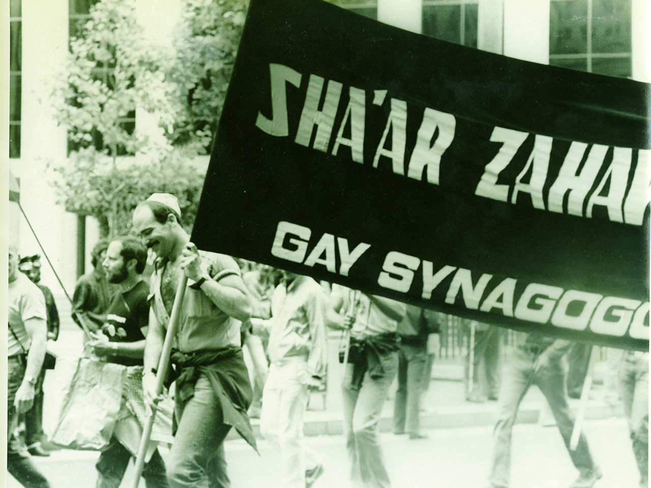 Bob Stein holds up the banner for recently formed Congregation Sha'ar Zahav in June 1979 during the San Francisco Gay Freedom Day Parade. (Photo/Joe Altman-California Historical Society)