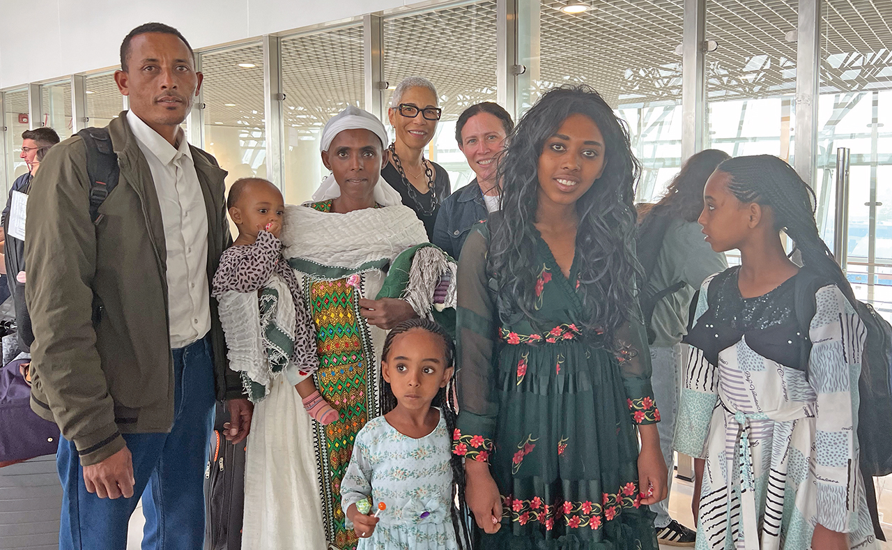 Incoming Weinberg Foundation board chair  Paula Pretlow (fourth from left) and Federation CEO Joy Sisisky (right of Pretlow) with an Ethiopian family making aliyah to Israel.