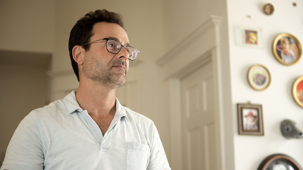 Man standing wearing glasses