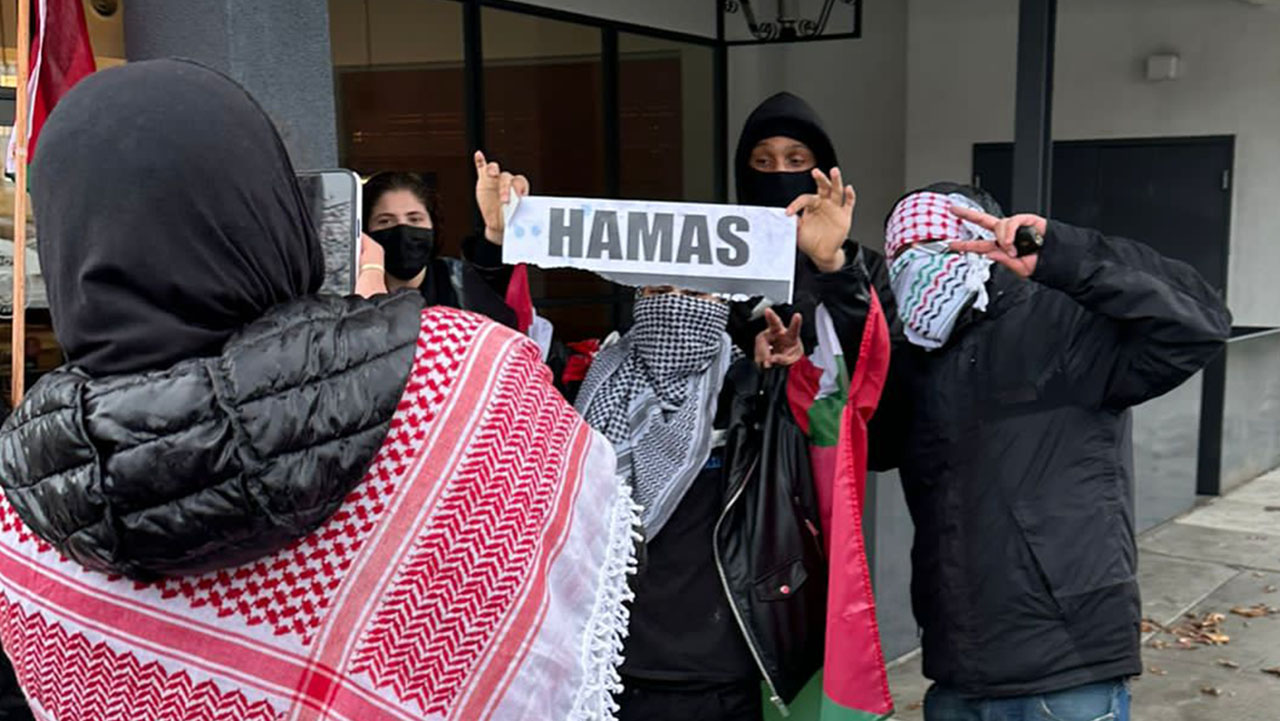 Protesters pose for a picture while holding a sign that says "Hamas" at a rally in El Cerrito, Jan. 6. (Photo/Courtesy)