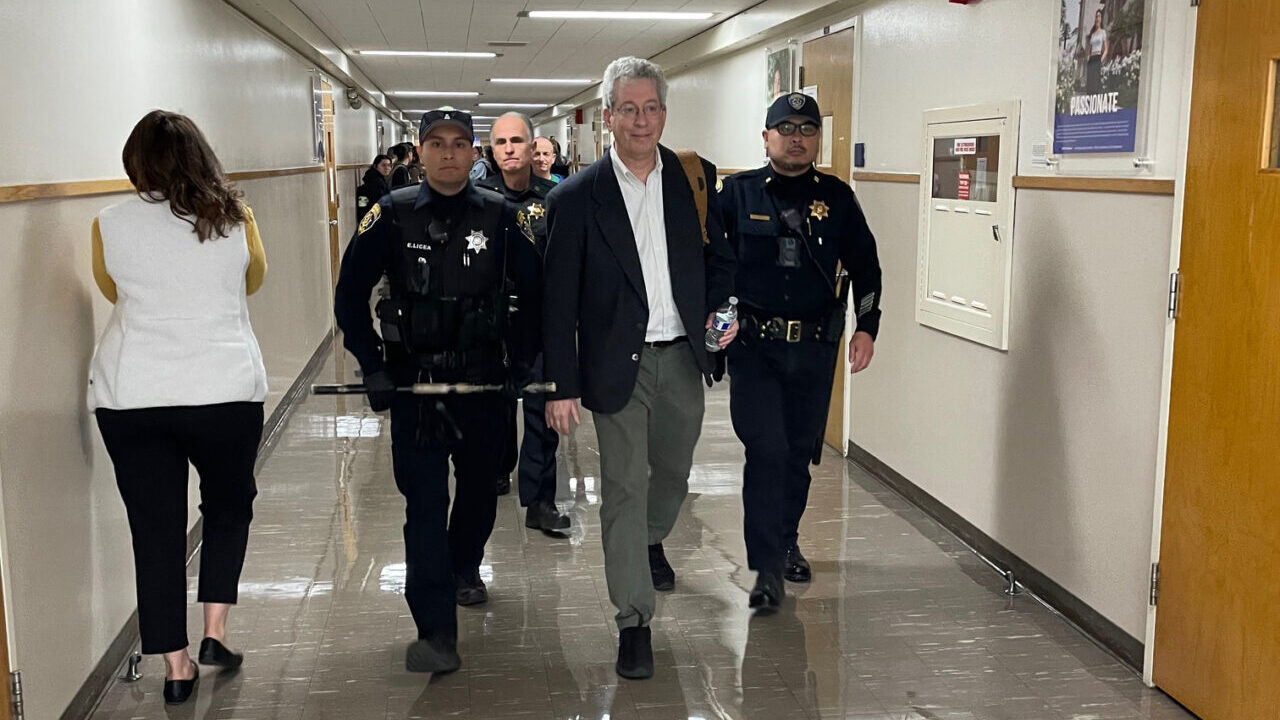 Police escort Cal State Long Beach professor Jeffrey Blutinger during his visit to lecture at San Jose State University in February 2024. (Hagit Shekel)
