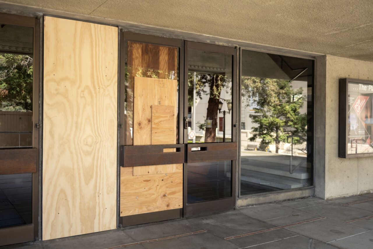 Plywood covers a shattered door and window at Zellerbach Hall on the UC Berkeley campus.