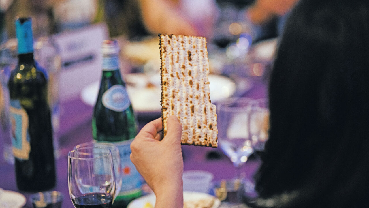 A Freedom Seder attendee holds up a piece of matzah. (Photo/Anastasiia Sapon-JCRC)
