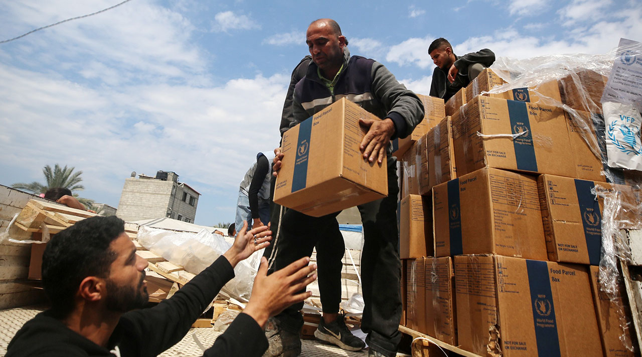 Palestinians distribute boxes of aid before the Eid al-Fitr holiday, which marks the end of Ramadan, amid the ongoing conflict between Israel and Hamas, in Deir Al-Balah, in the central Gaza Strip, on April 8, 2024. (Photo/JTA-Majdi Fathi-NurPhoto via Getty Images)