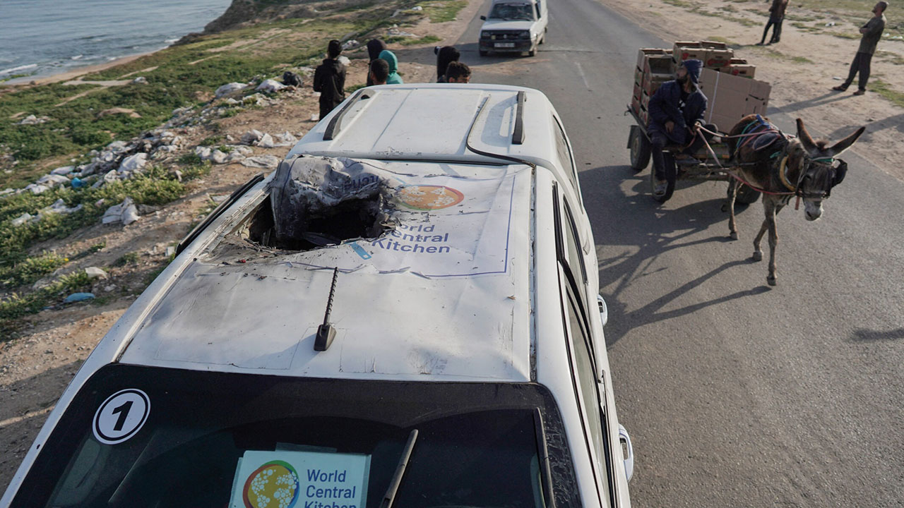 People gather around the damaged car used by U.S.-based aid group World Central Kitchen, that was hit by an Israeli strike in Deir al-Balah in the central Gaza Strip on April 2, 2024. (Photo/JTA-AFP via Getty Images)