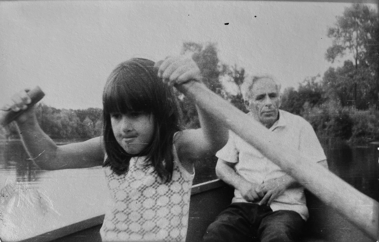 A young Sasha Vasilyuk with her grandfather on a lake in Ukraine. (Photo/Courtesy)
