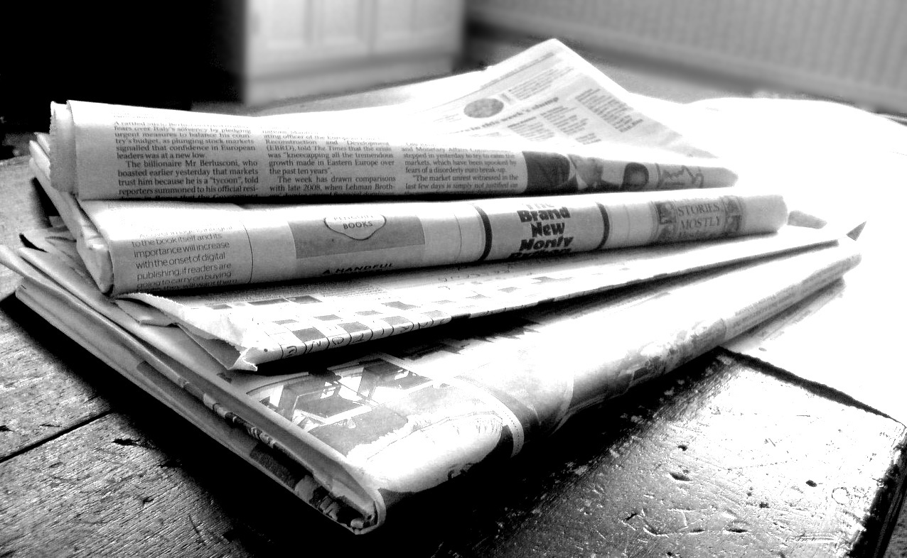 black and white photo of a stack of newspapers