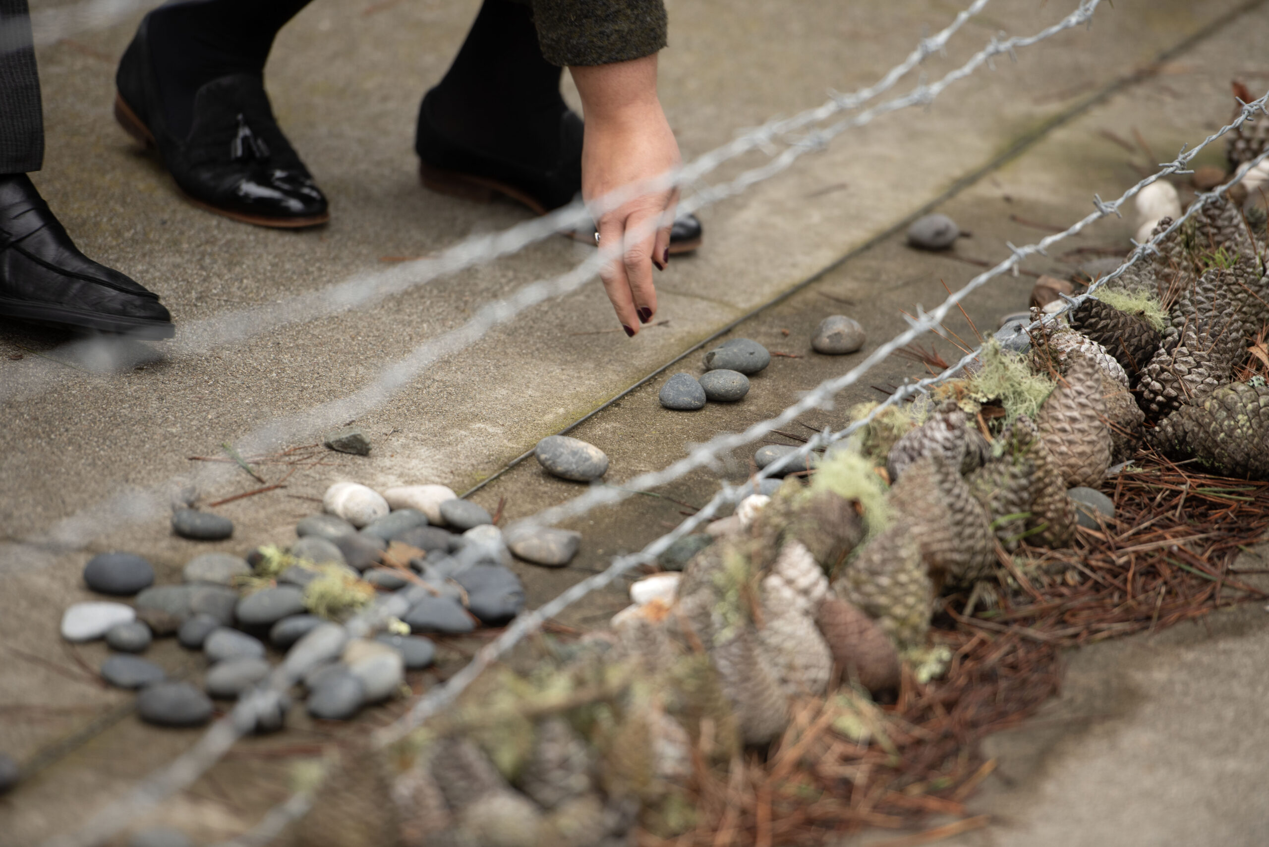 A visitor places a stone at the Holocaust memorial at San Francisco’s Legion of Honor. (Photo/Aaron Levy-Wolins)