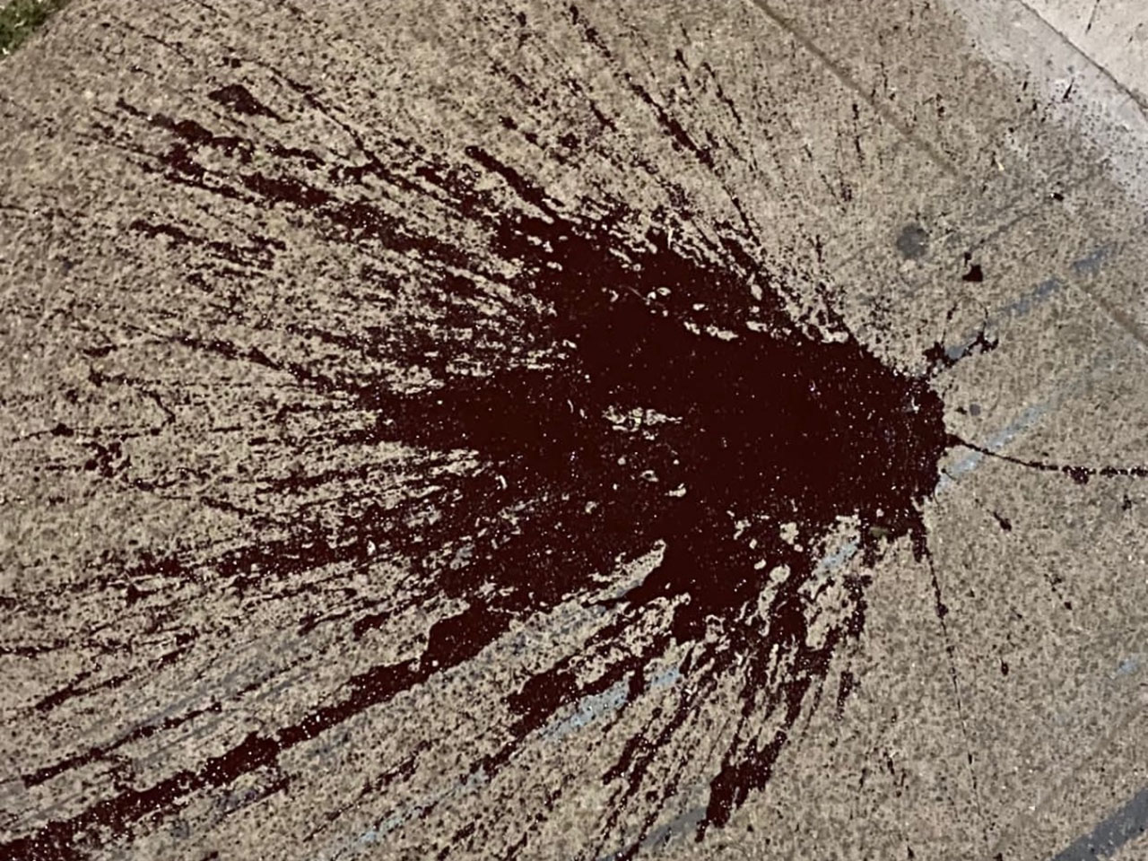 Red paint splattered on the ground outside the venue. (Photo/Courtesy)