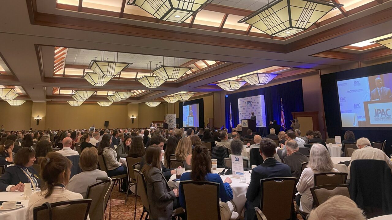 People sitting at tables in a ballroom