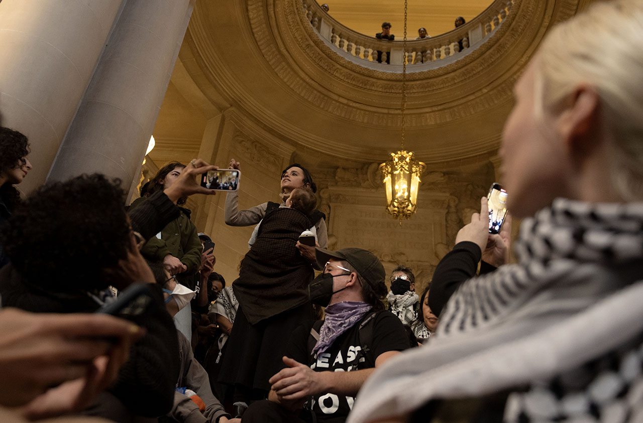 Lara Kiswani (center), executive director of the Arab Resource and Organizing Center, speaks in the San Francisco City Hall rotunda on Jan. 9, 2024, during efforts to pass a Gaza cease-fire resolution. (Photo/Aaron Levy-Wolins)