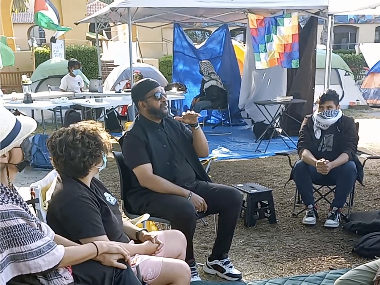 Amir Abdel Malik Ali, an imam who spreads antisemitic conspiracy theories, speaks at the Stanford pro-Palestine encampment, May 22, 2024. (Screenshot/Courtesy David Atri)