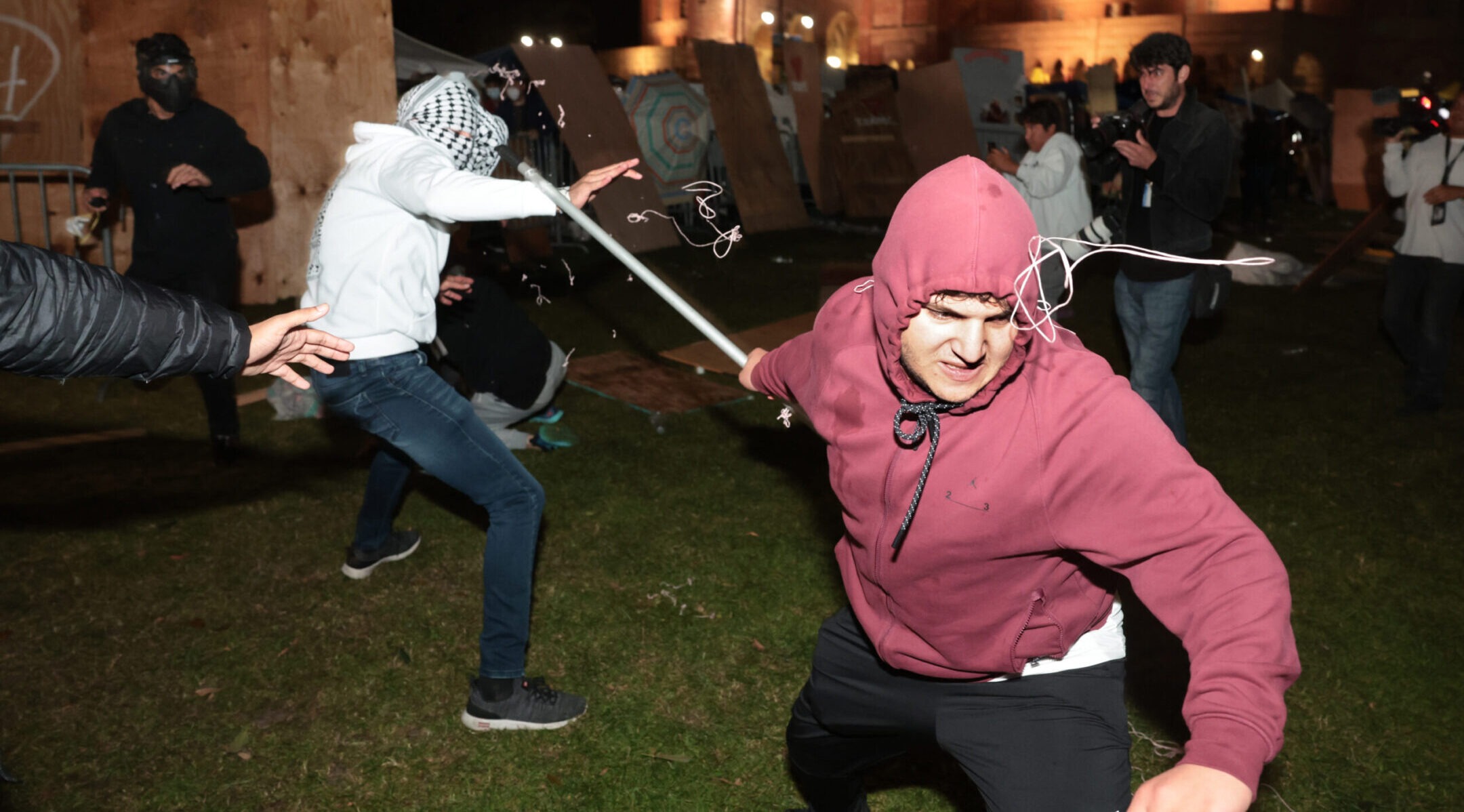 Pro-Palestinian and pro-Israel protesters clash during violence at an encampment at UCLA early in the morning of May 1, 2024. (Wally Skalij/Los Angeles Times via Getty Images)