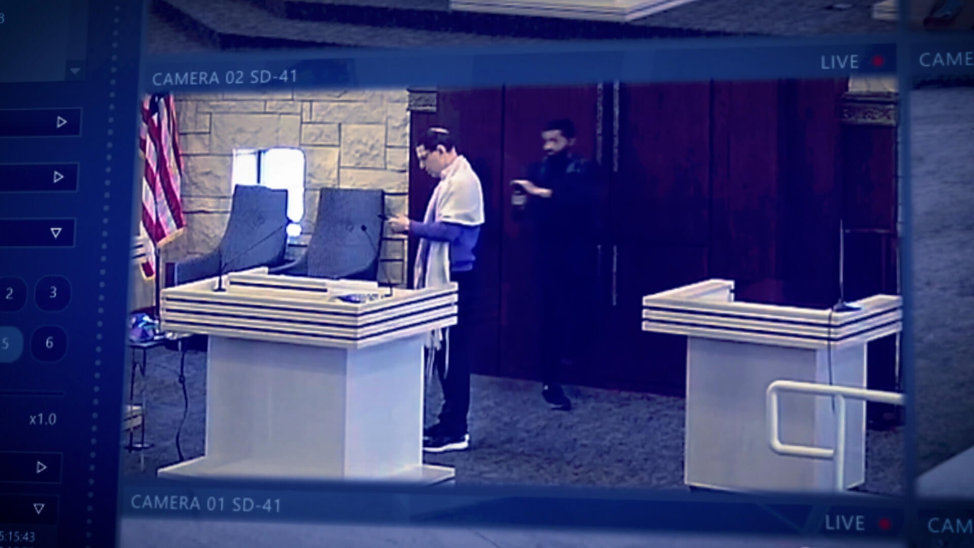 Malik Akram, left, holds a gun to Rabbi Charlie Cytron-Walker in a scene from the "Colleyville" documentary. (Courtesy of Hey Jude Productions)