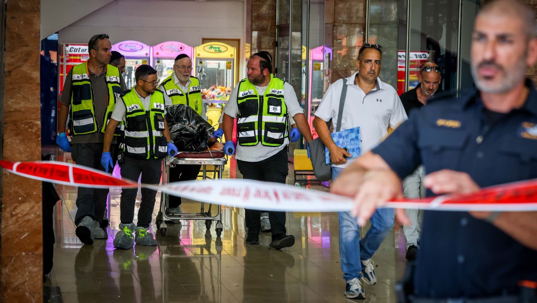 Police and rescue forces outside the scene of a stabbing attack in Carmiel, northern Israel, July 3, 2024. (David Cohen/Flash90)