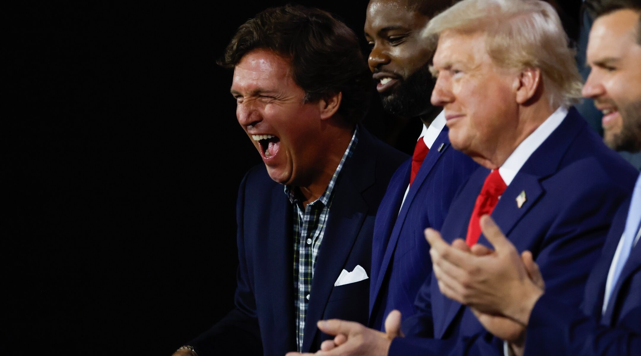 Tucker Carlson, U.S. Rep. Byron Donalds of Florida, former U.S. President Donald Trump, Sen. J.D. Vance of Ohio appear on the first day of the Republican National Convention at the Fiserv Forum on Milwaukee, July 15, 2024. (Chip Somodevilla/Getty Images)