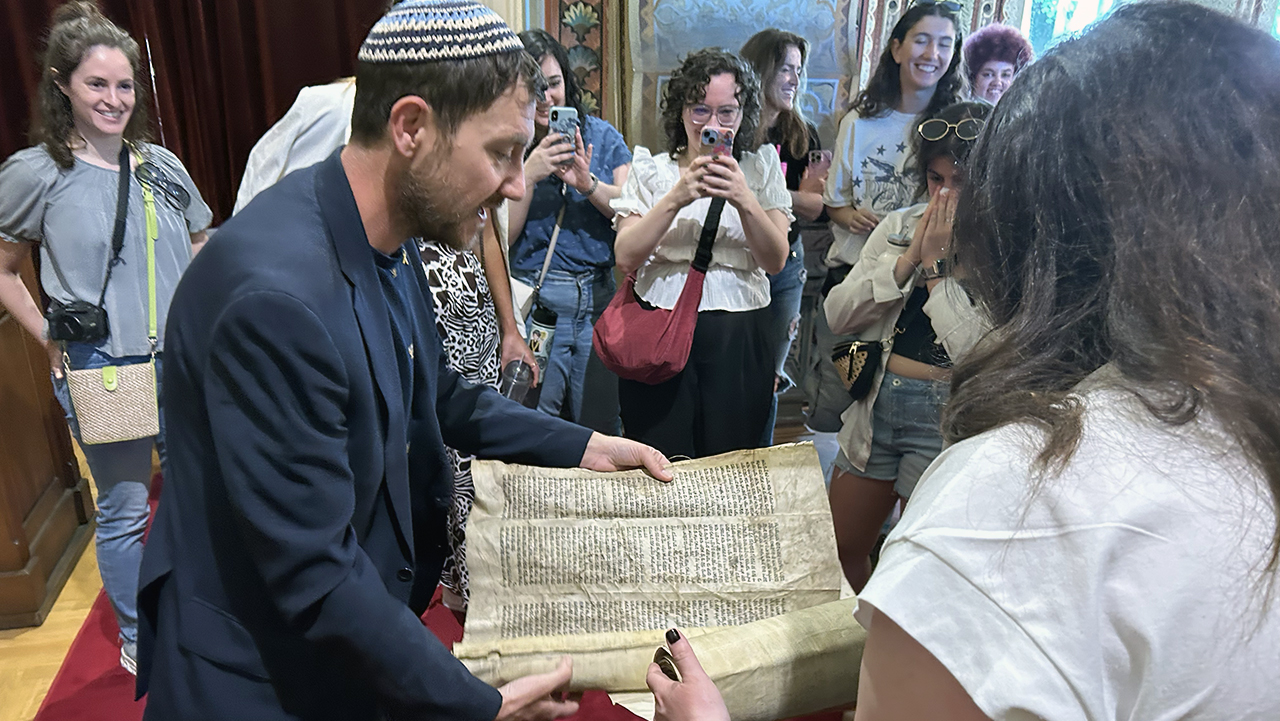Igor Bencion Kožemjakin reads aloud from an antique Torah scroll housed in the Sephardic synagogue of Sarajevo. (Courtesy)
